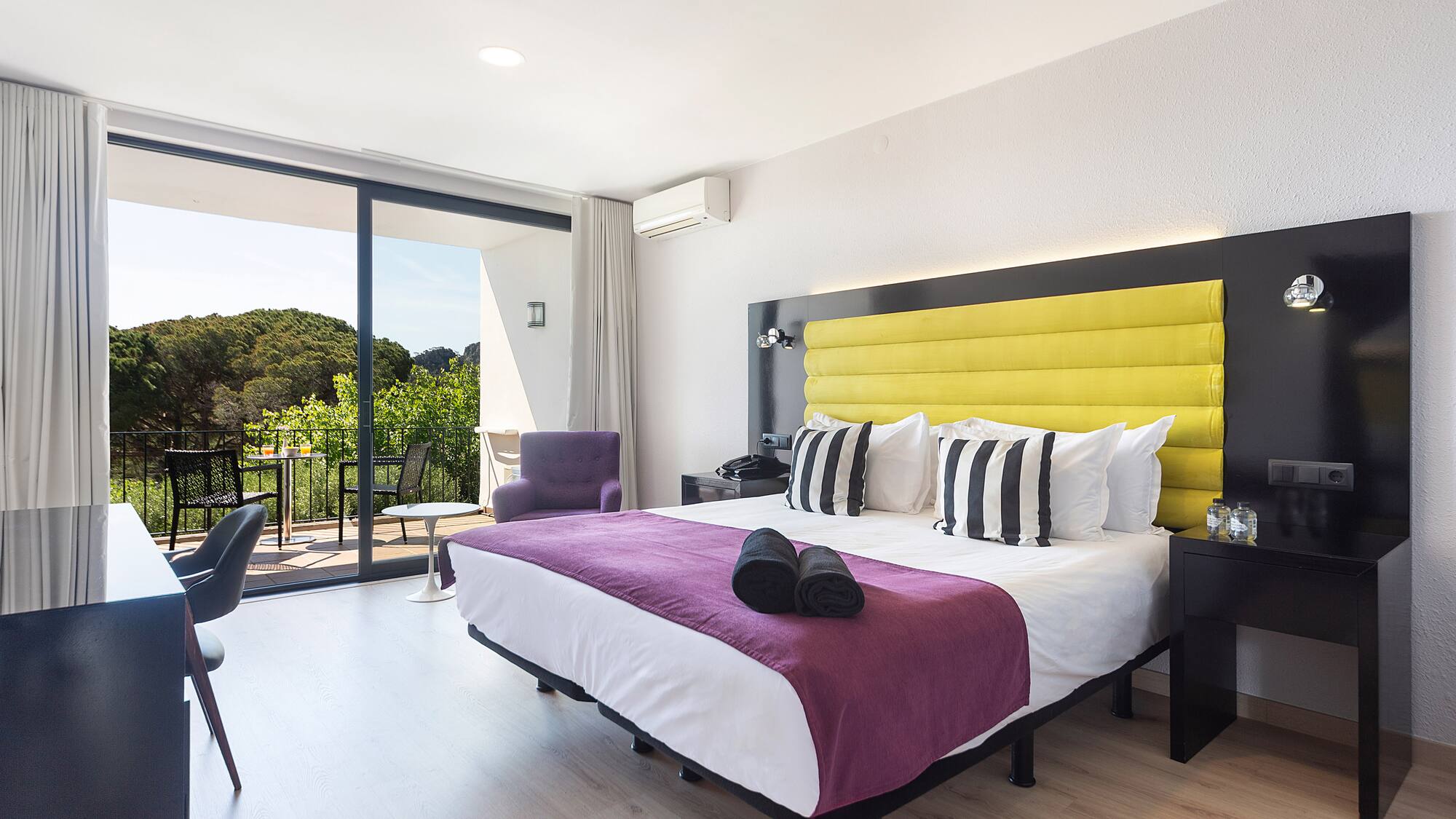 a room with a bed and a glass door