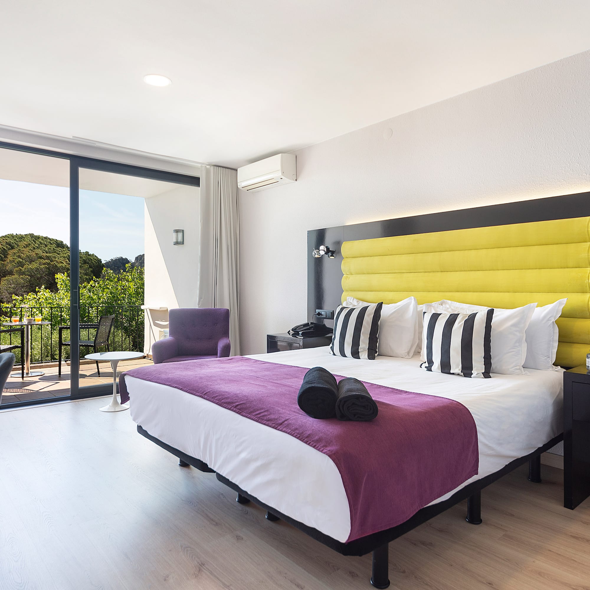 a room with a bed and a glass door