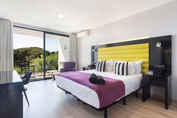 a room with a bed and a glass door