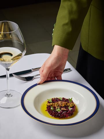 a hand holding a plate of food