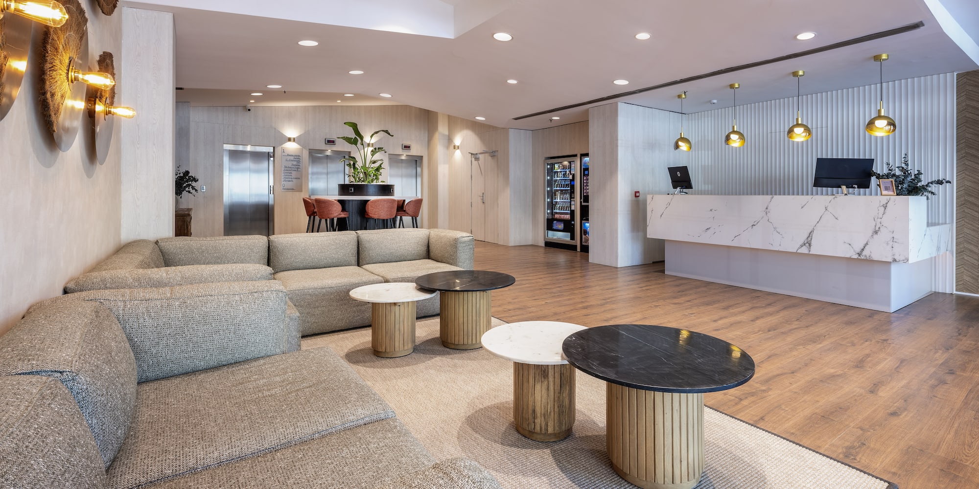 a lobby with a couch and tables