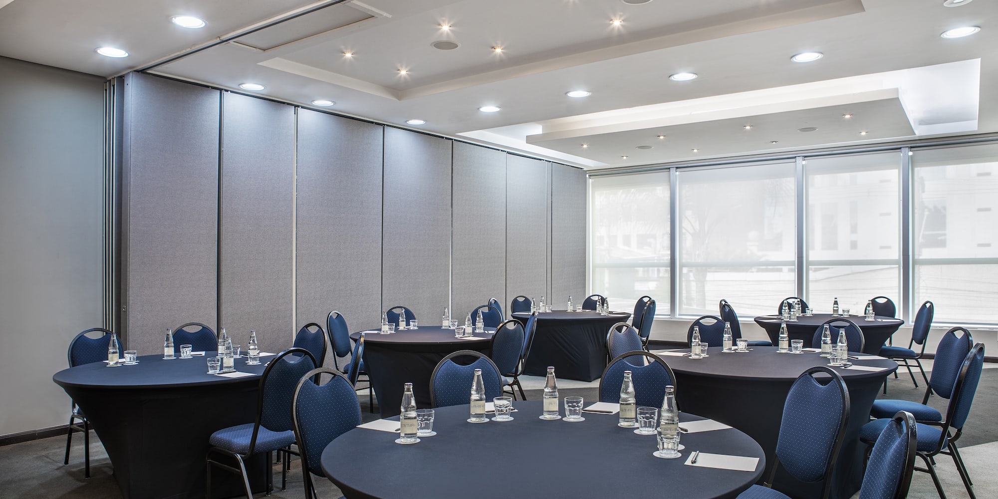 a room with round tables and chairs