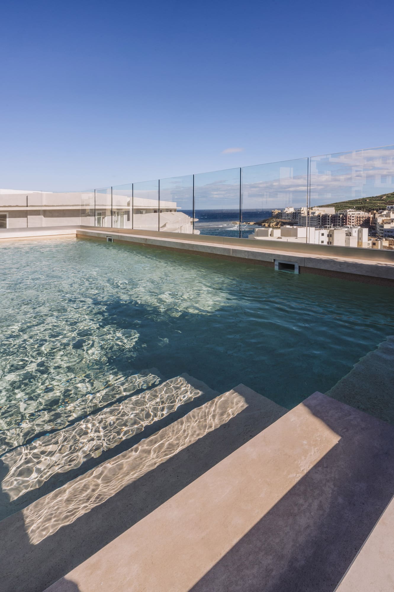 a pool with steps leading to a building