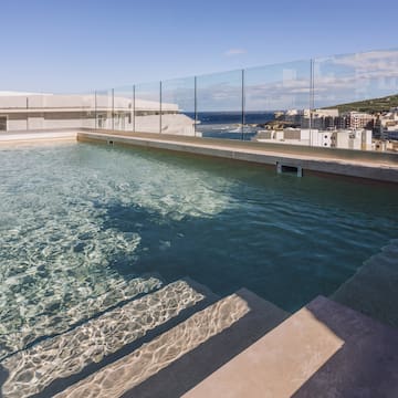 a pool with steps leading to a building
