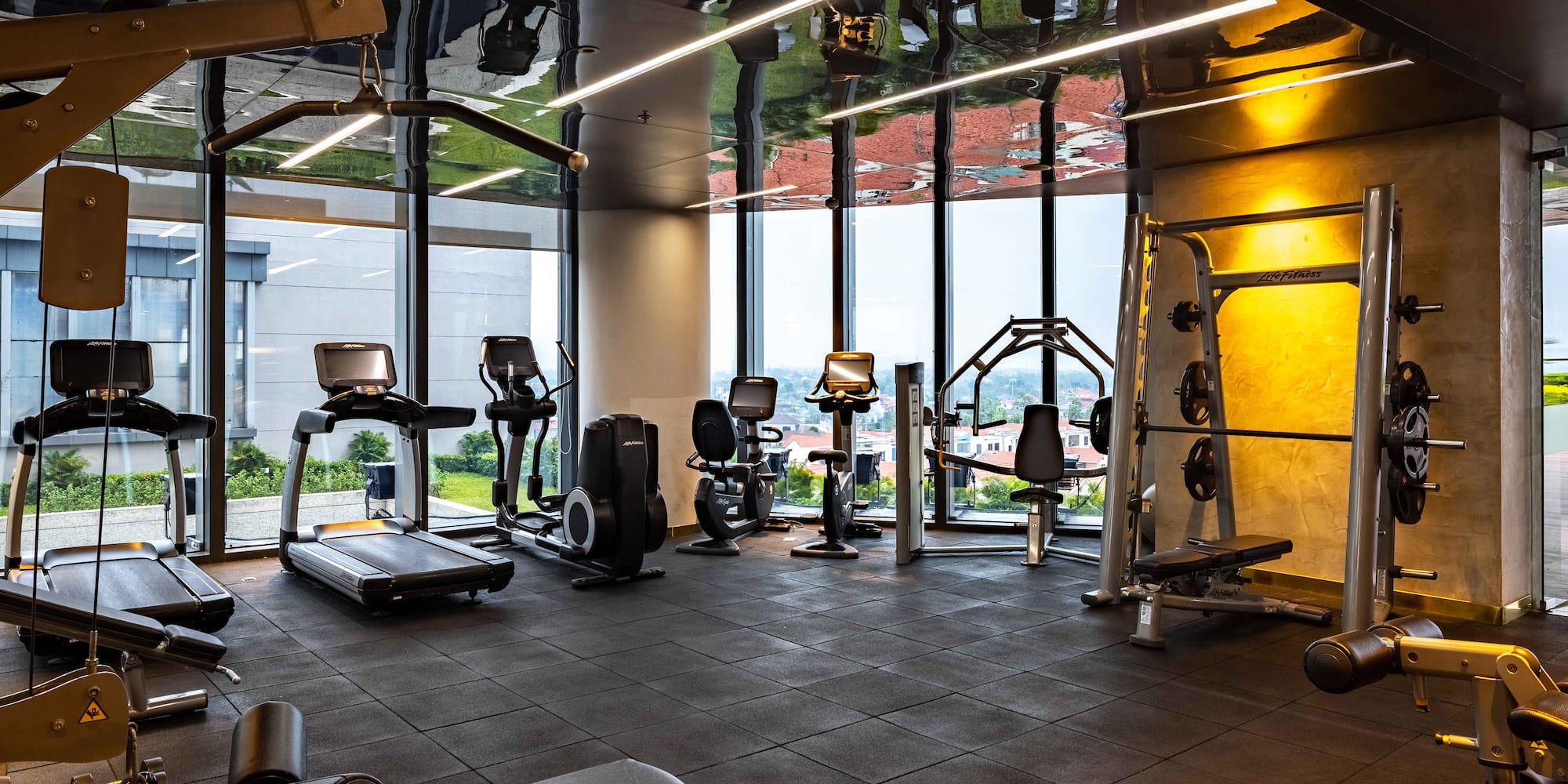 a room with exercise equipment and a large window
