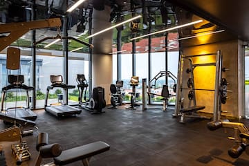 a room with exercise equipment and a large window