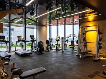 a room with exercise equipment and a large window