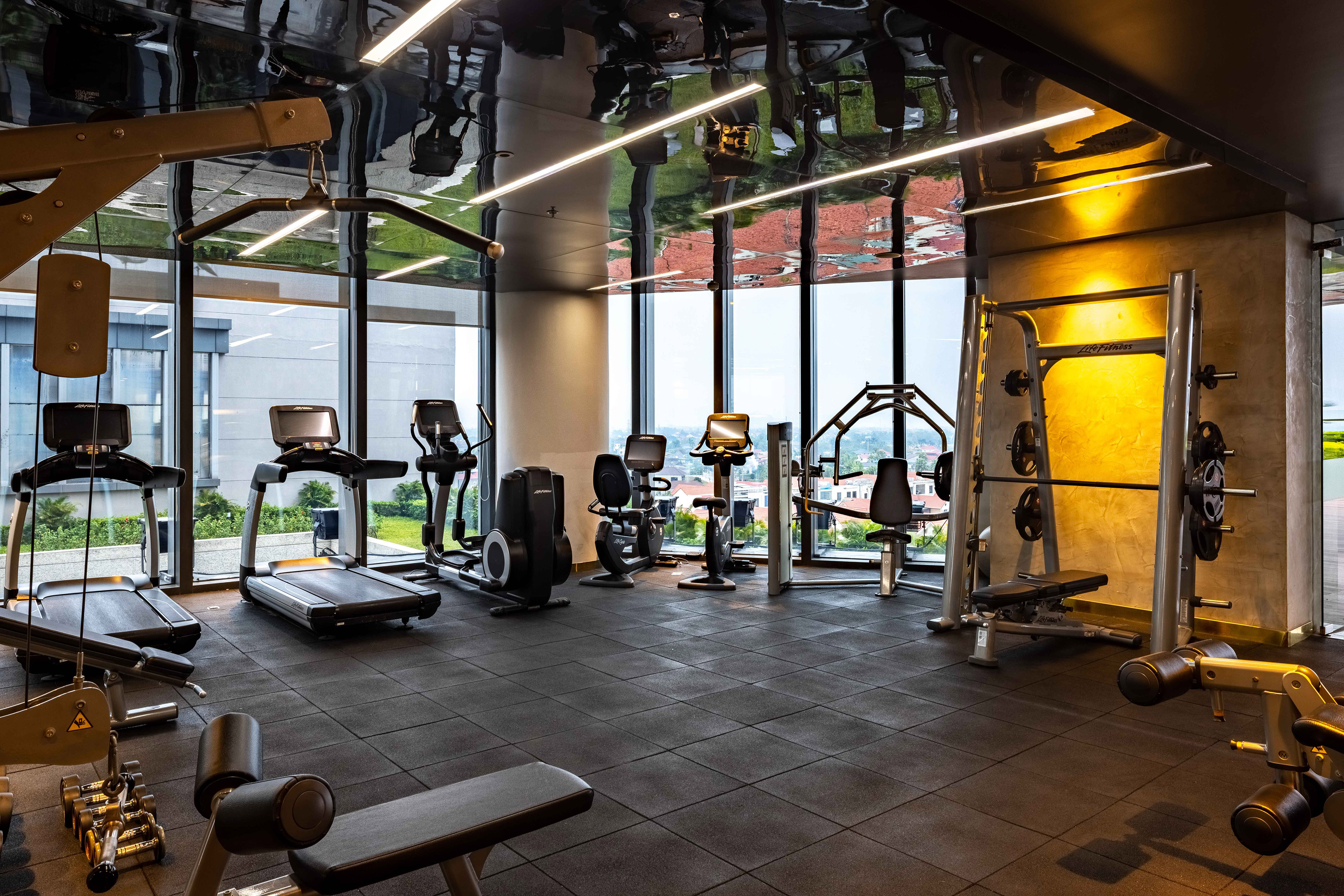 a room with exercise equipment and a large window