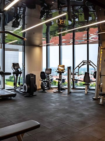 a room with exercise equipment and a large window