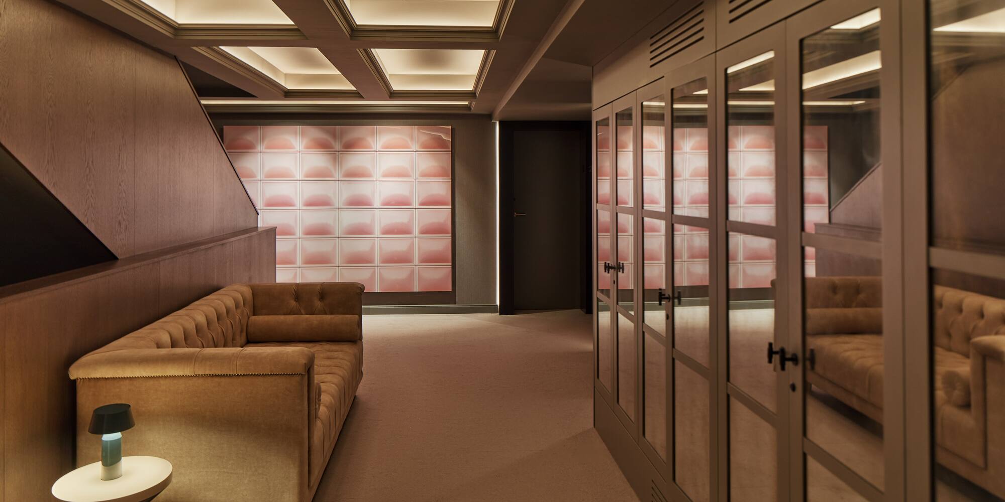 a room with a couch and glass doors