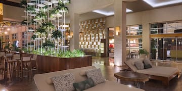 a room with a couch and chairs