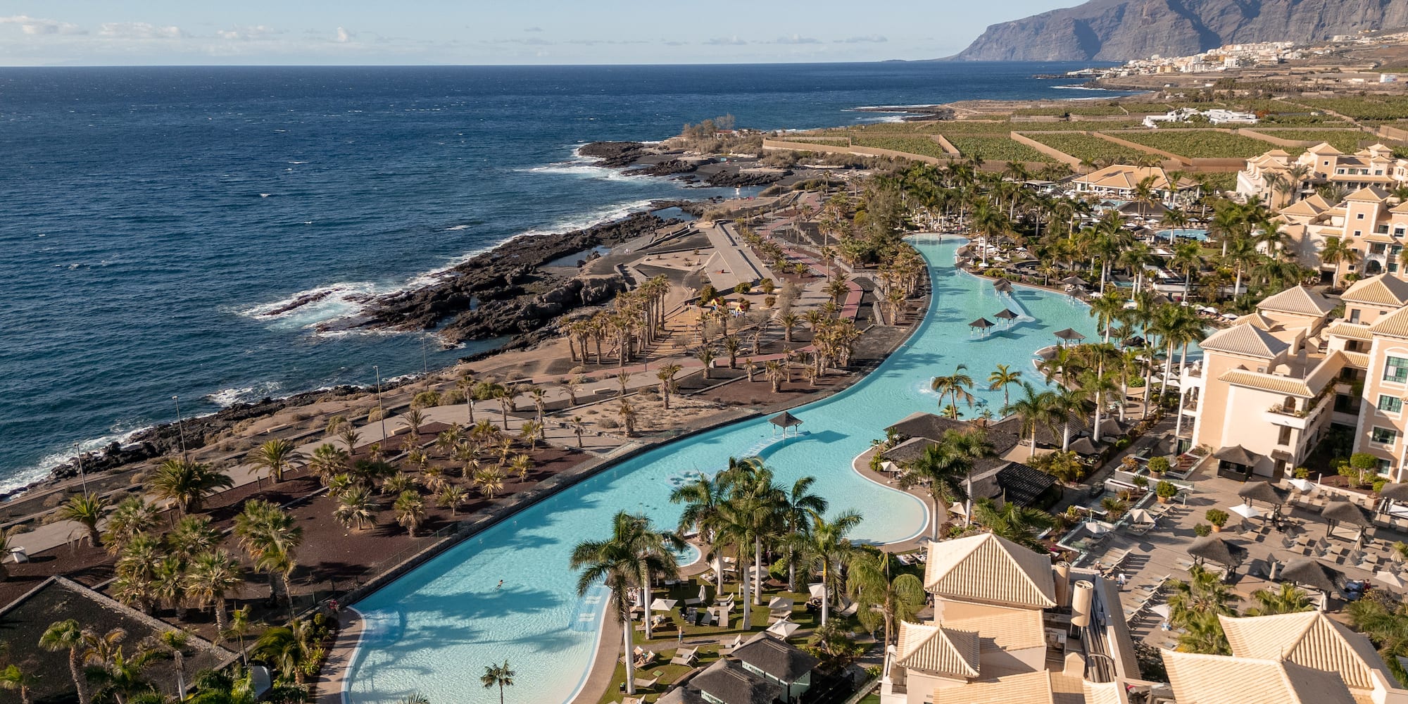 a swimming pool next to a body of water