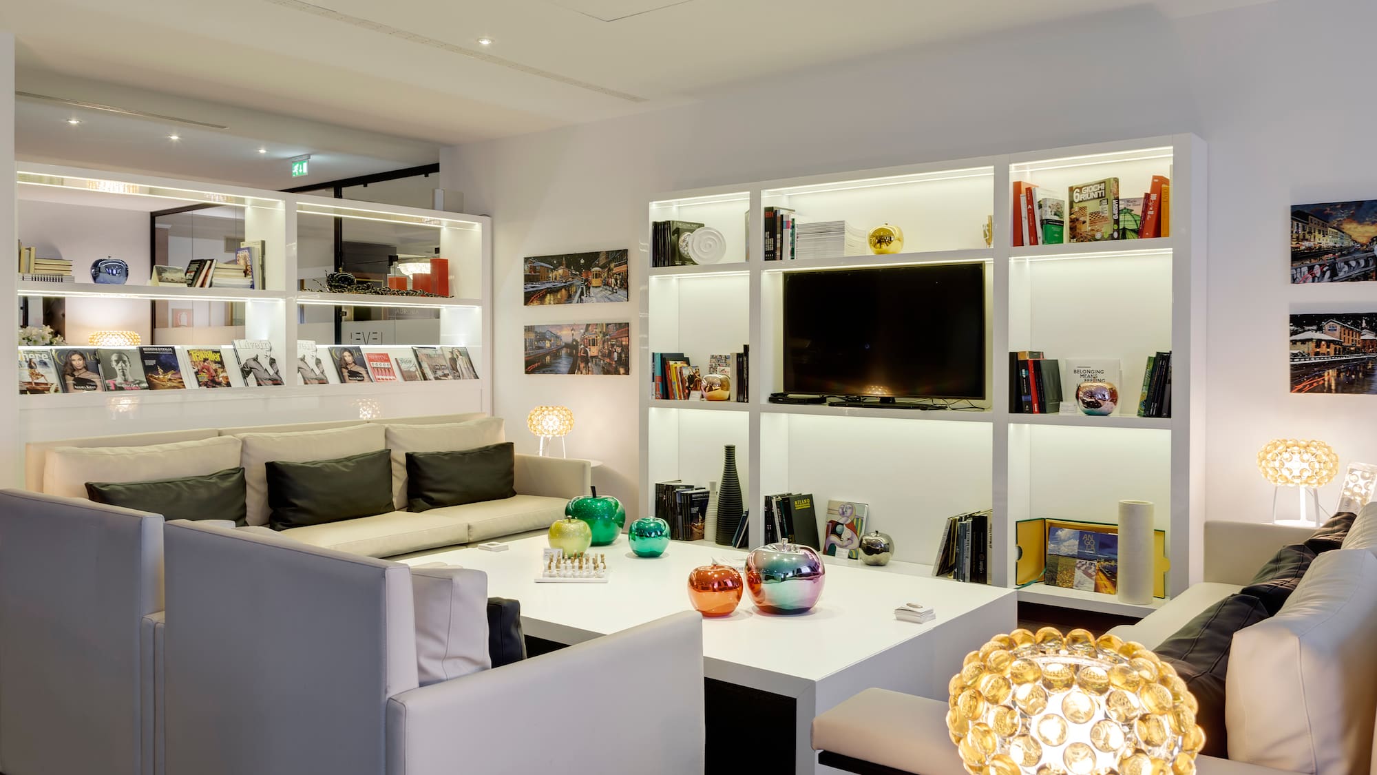 a room with white furniture and shelves