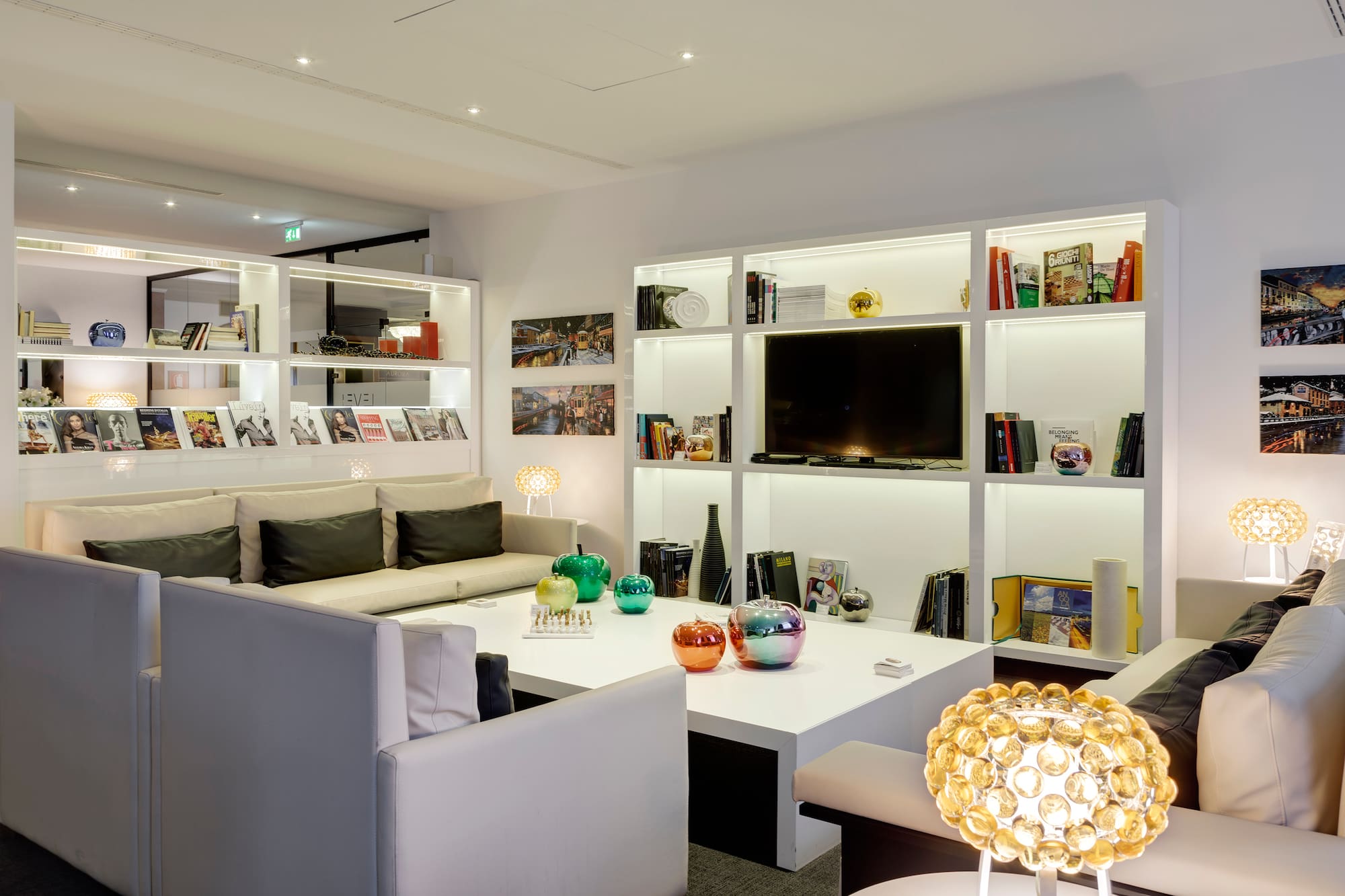 a room with white furniture and shelves