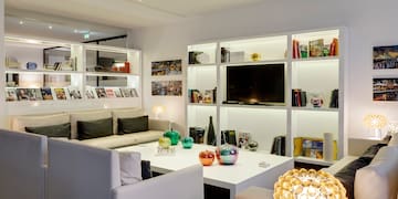 a room with white furniture and shelves