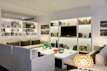 a room with white furniture and shelves