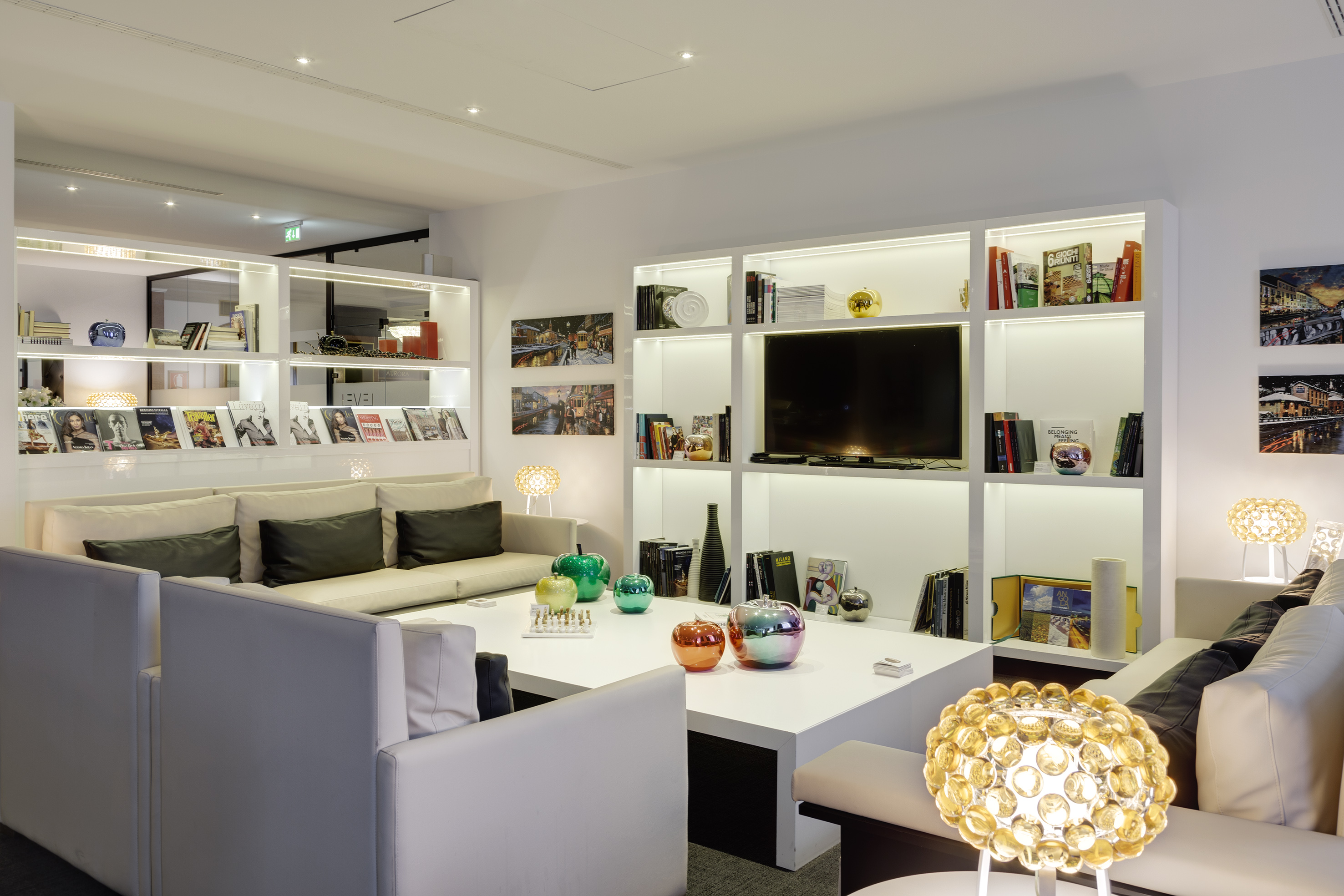 a room with white furniture and shelves