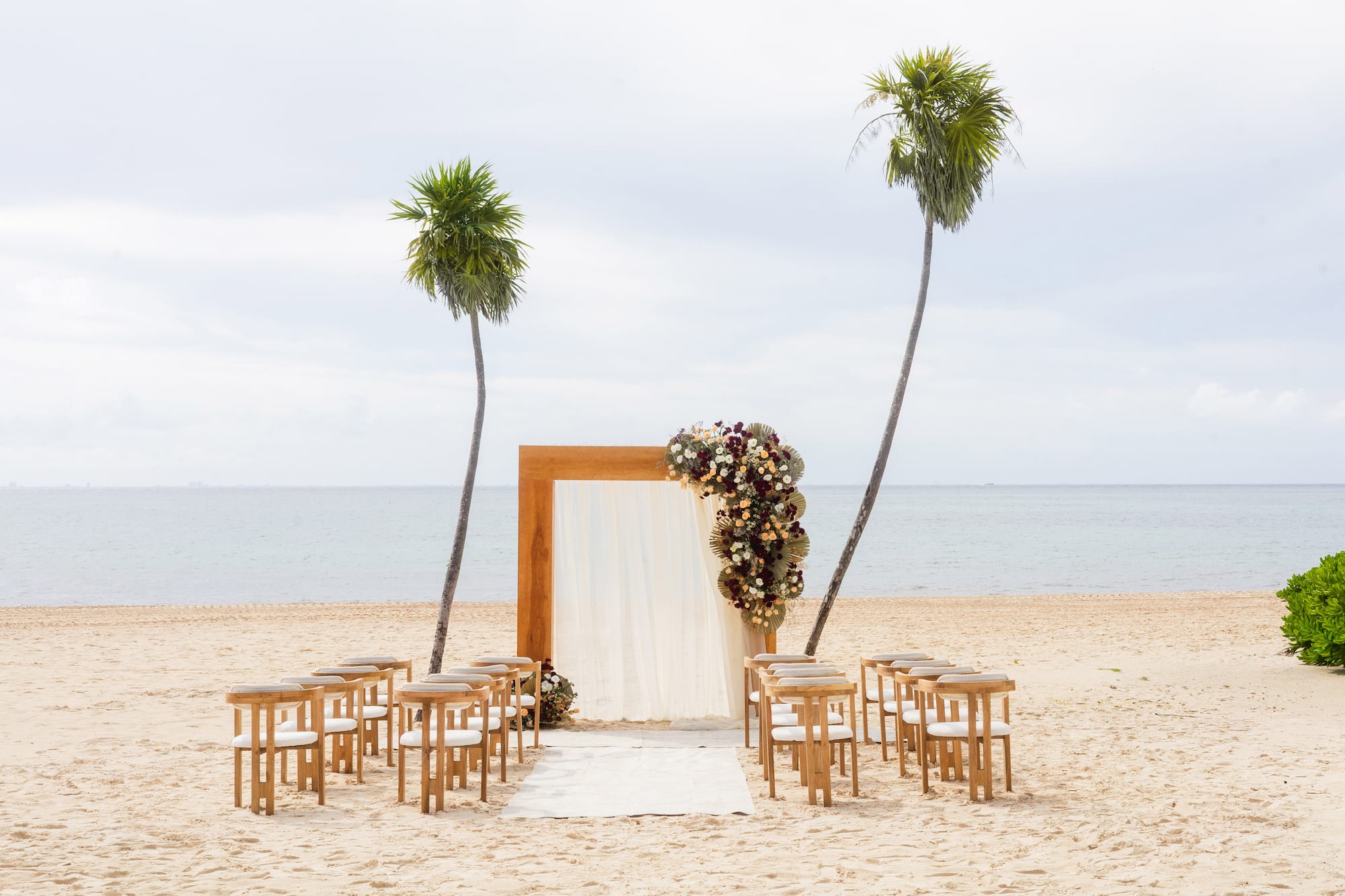 a beach with chairs and a arch