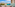 Ocean view balcony with beach, coastal city, mountains. Drinks and lounge chairs.