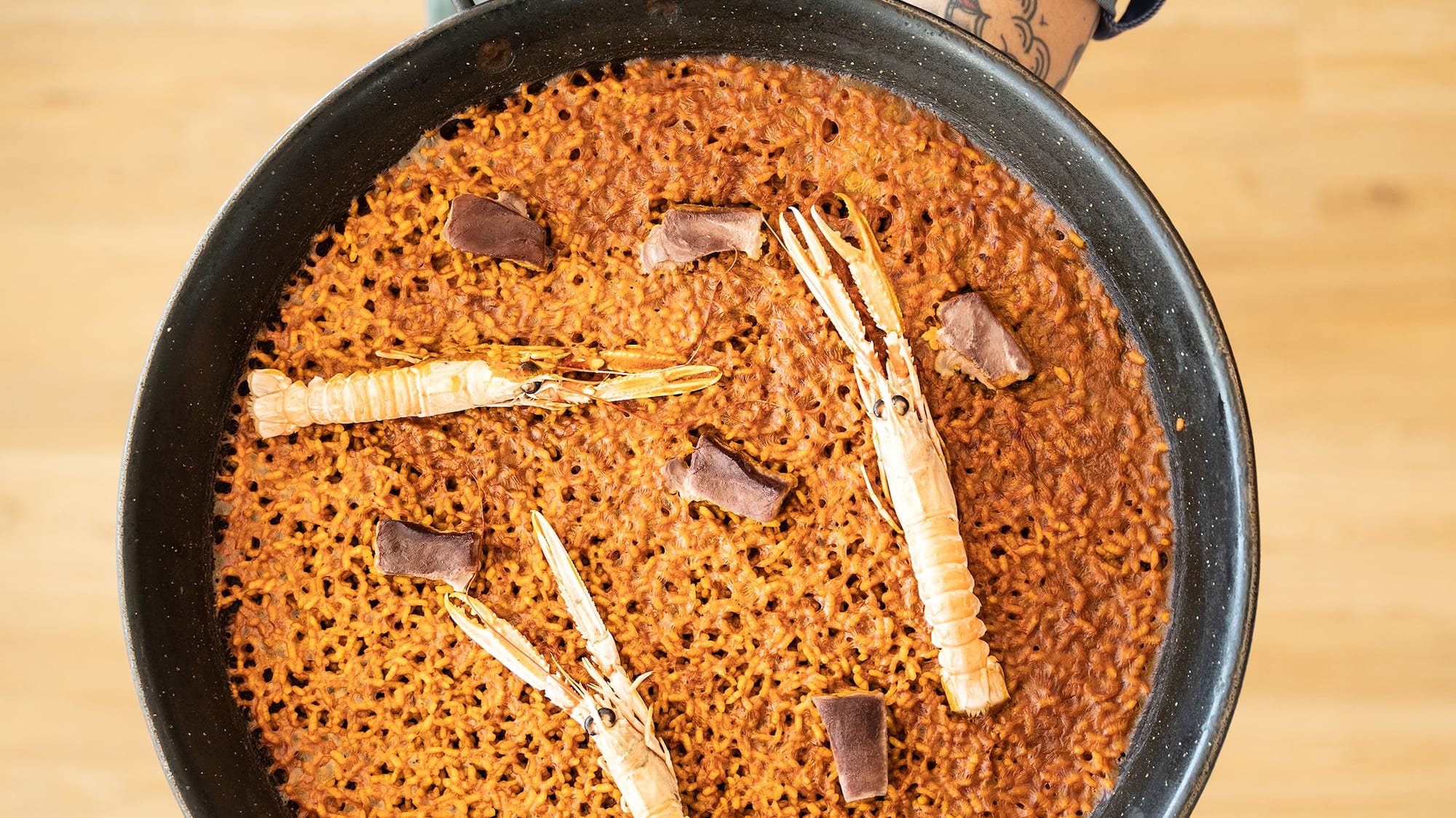 a person holding a pan of food