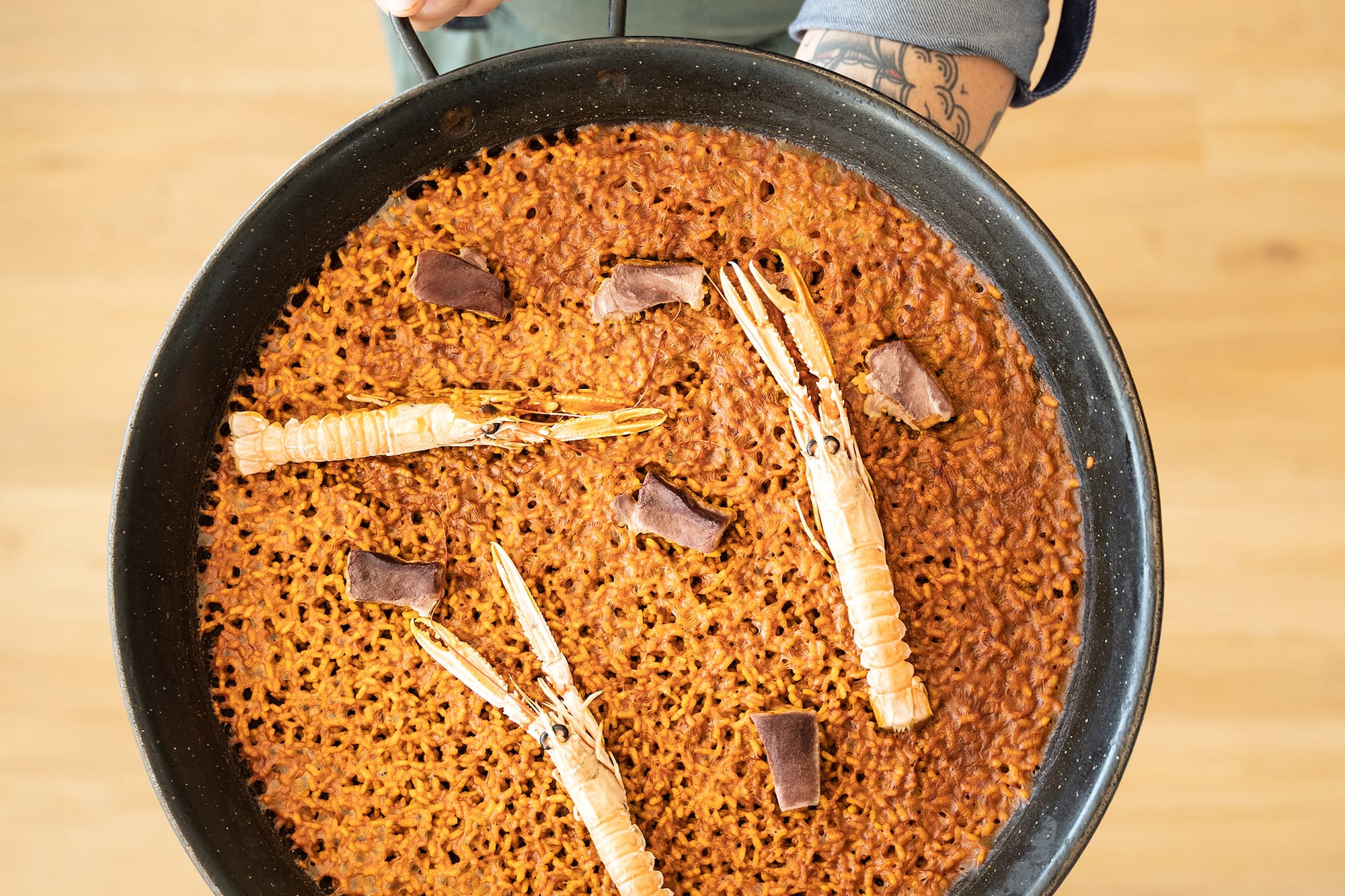 a person holding a pan of food