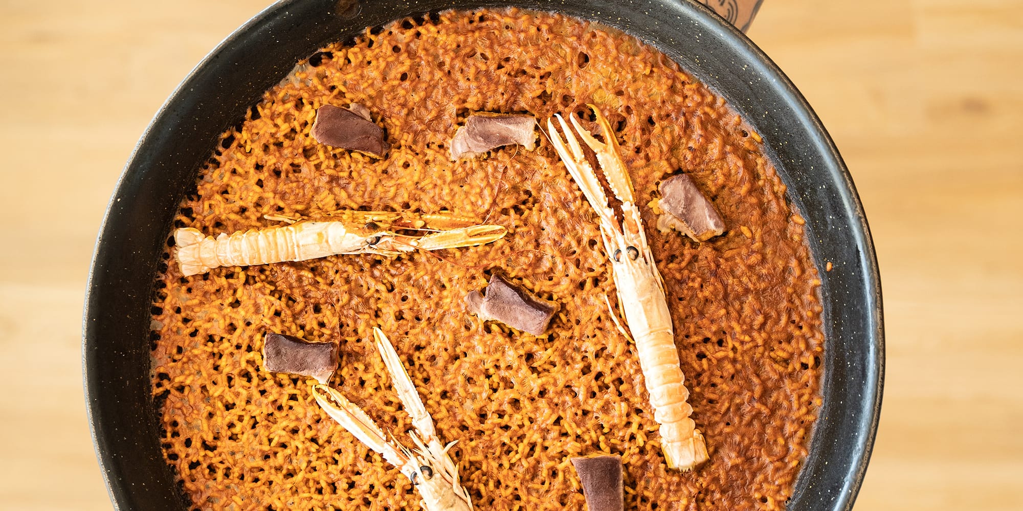 a person holding a pan of food
