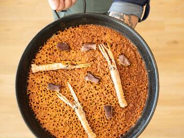 a person holding a pan of food