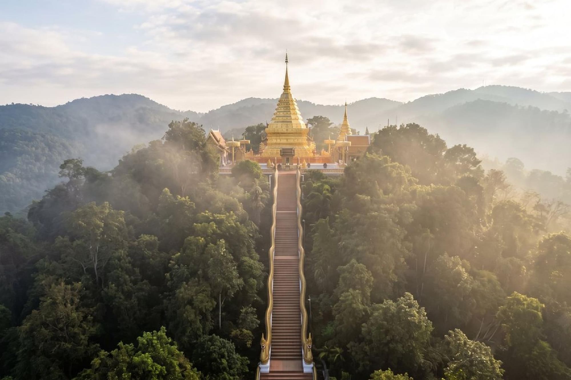 Wat Phra That Doi Suthep golden temple on misty mountain, Chiang Mai.