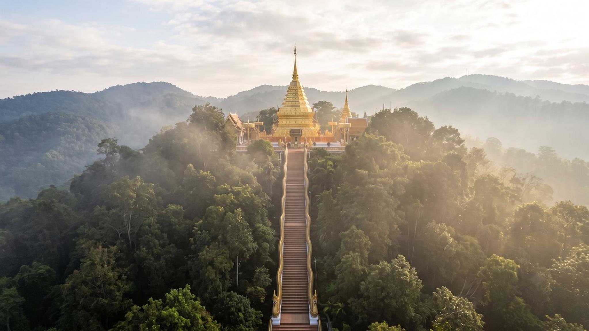Wat Phra That Doi Suthep golden temple on misty mountain, Chiang Mai.