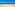 Golden sand beach, turquoise ocean, blue sky, people, distant sailboats.