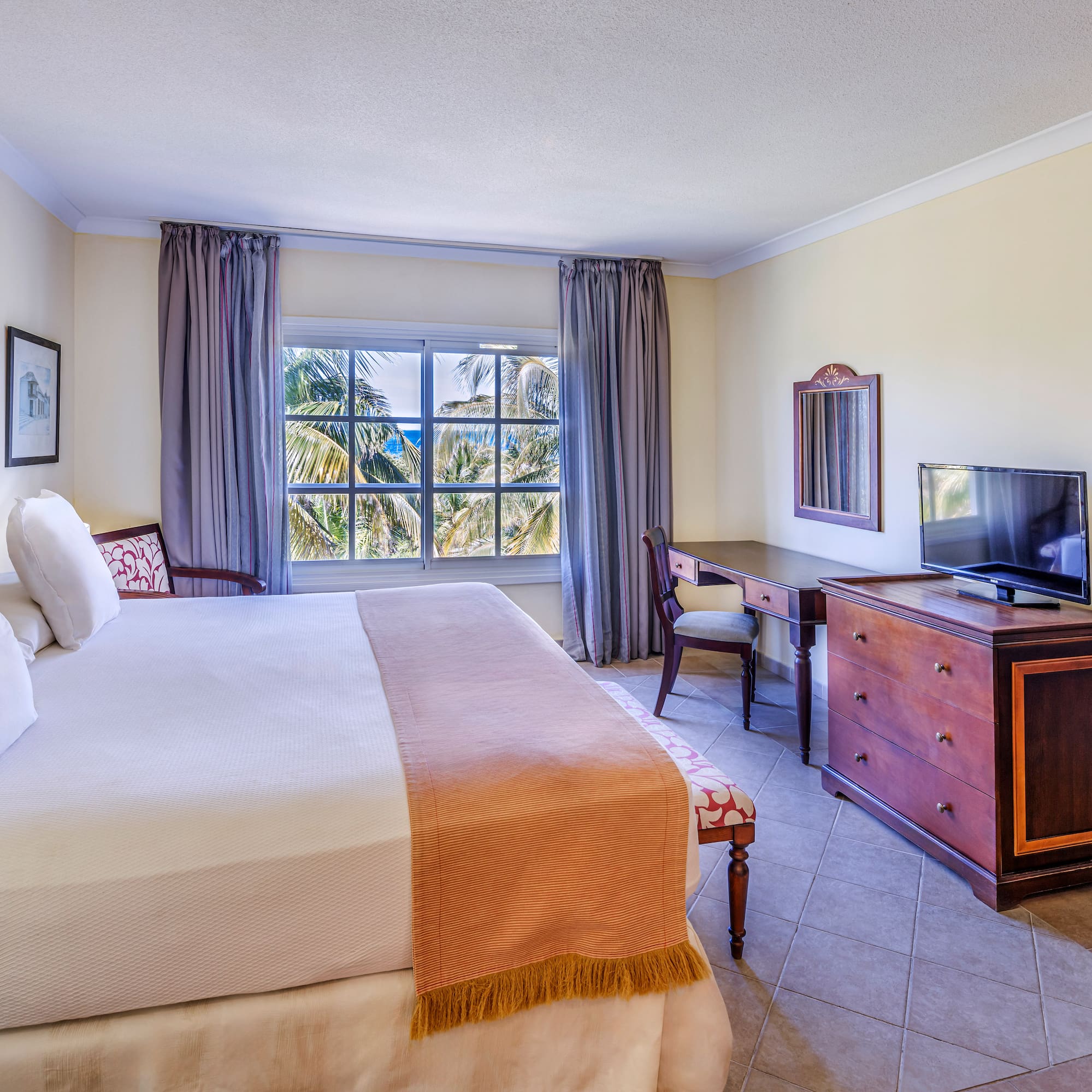 a bedroom with a large bed and a television