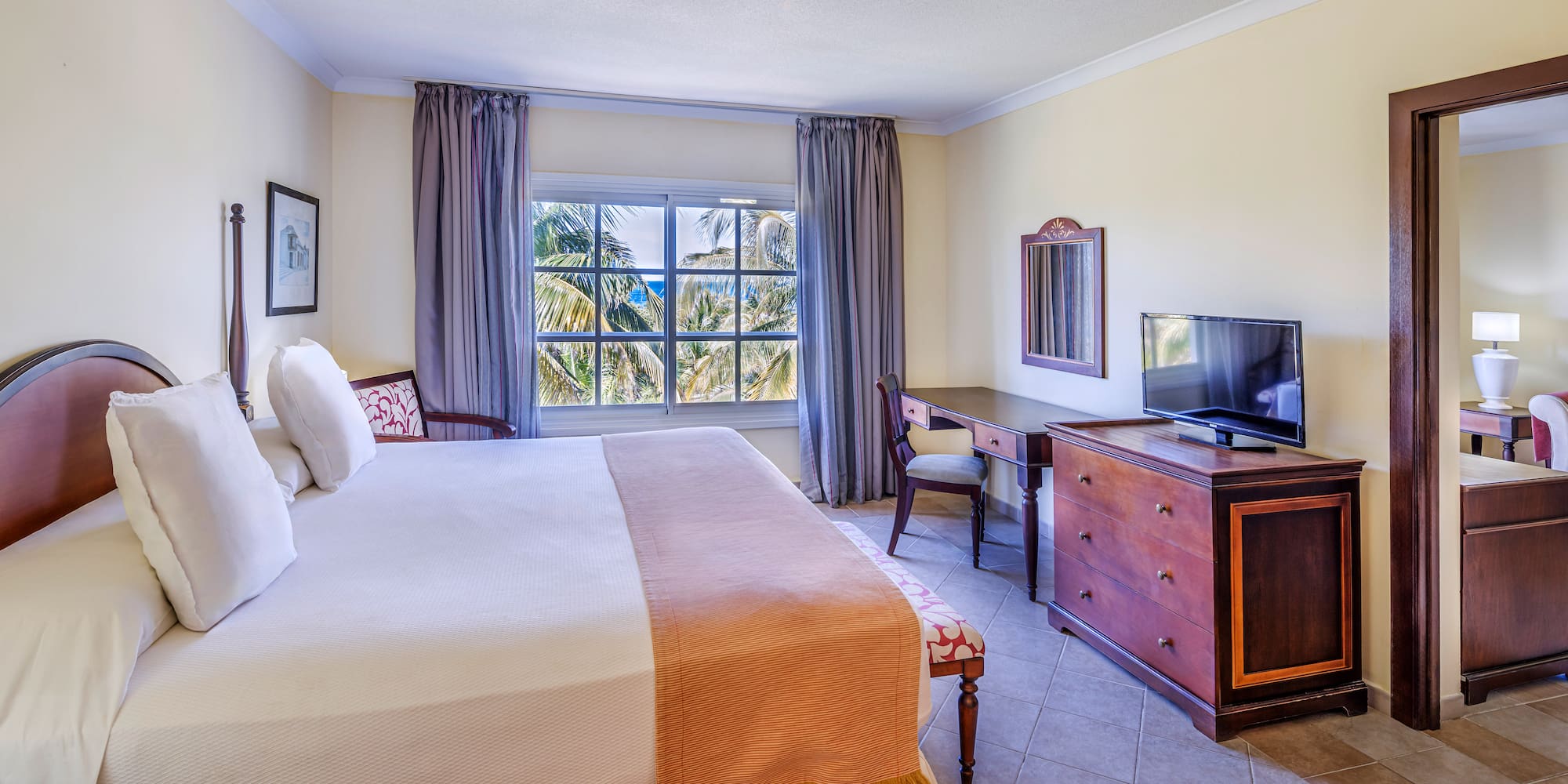 a bedroom with a large bed and a television