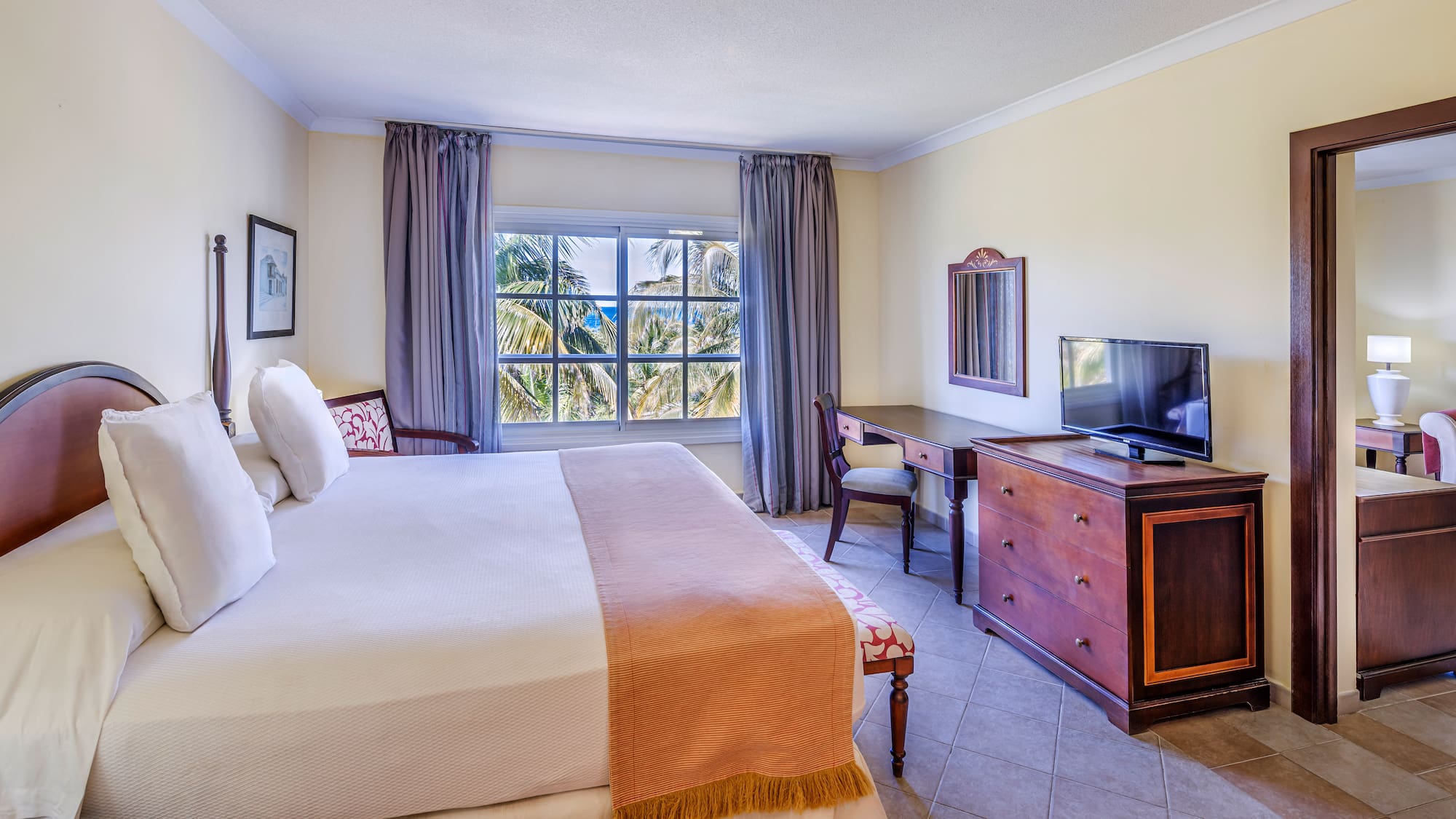 a bedroom with a large bed and a television