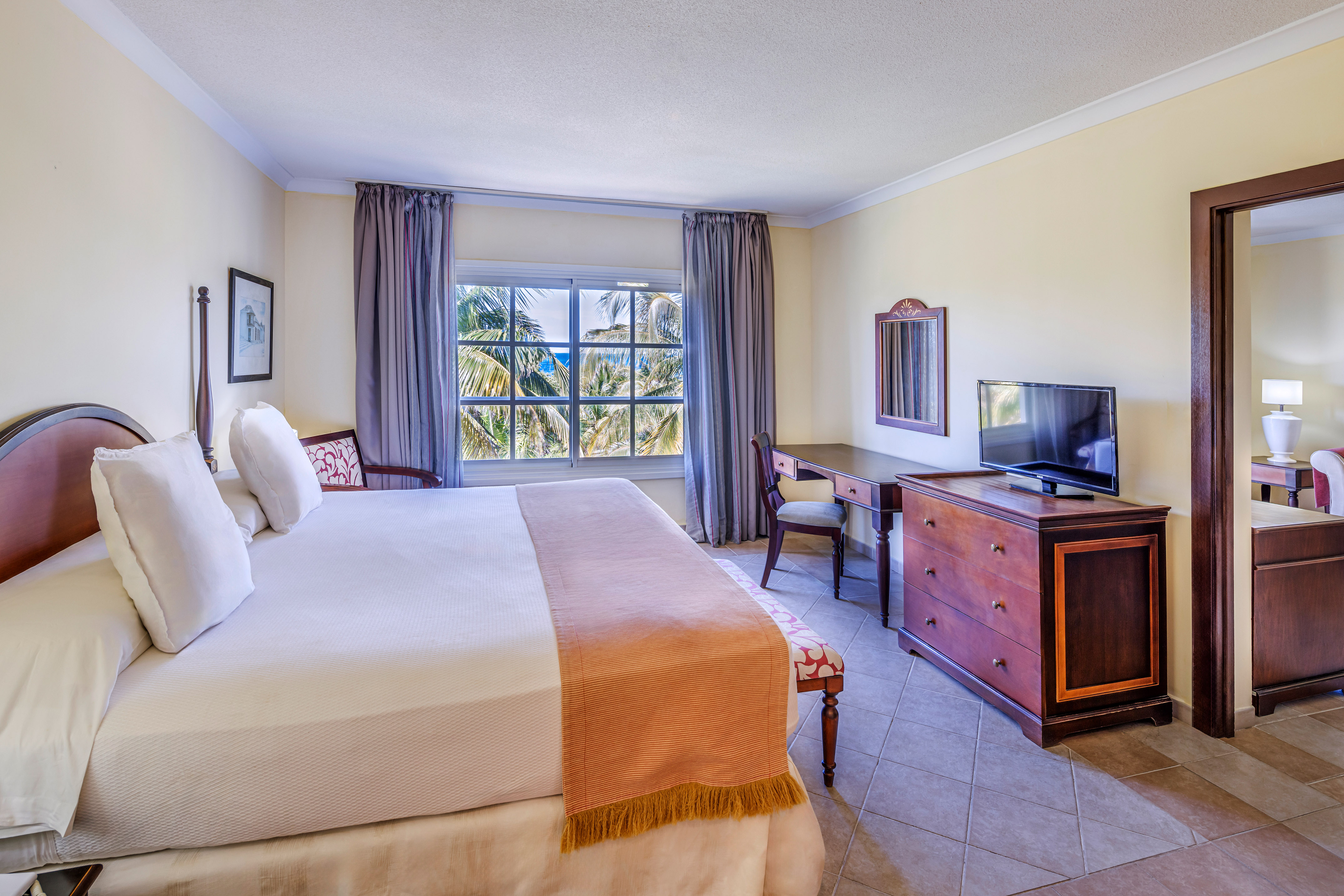 a bedroom with a large bed and a television