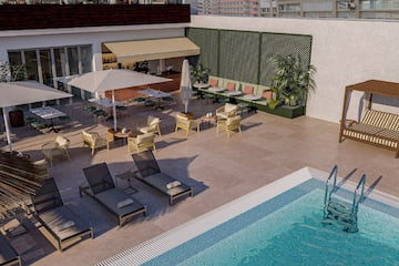 a pool with chairs and umbrellas