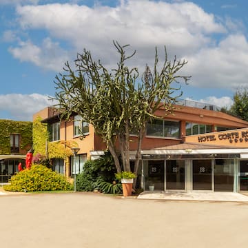 a building with a tree and a sign