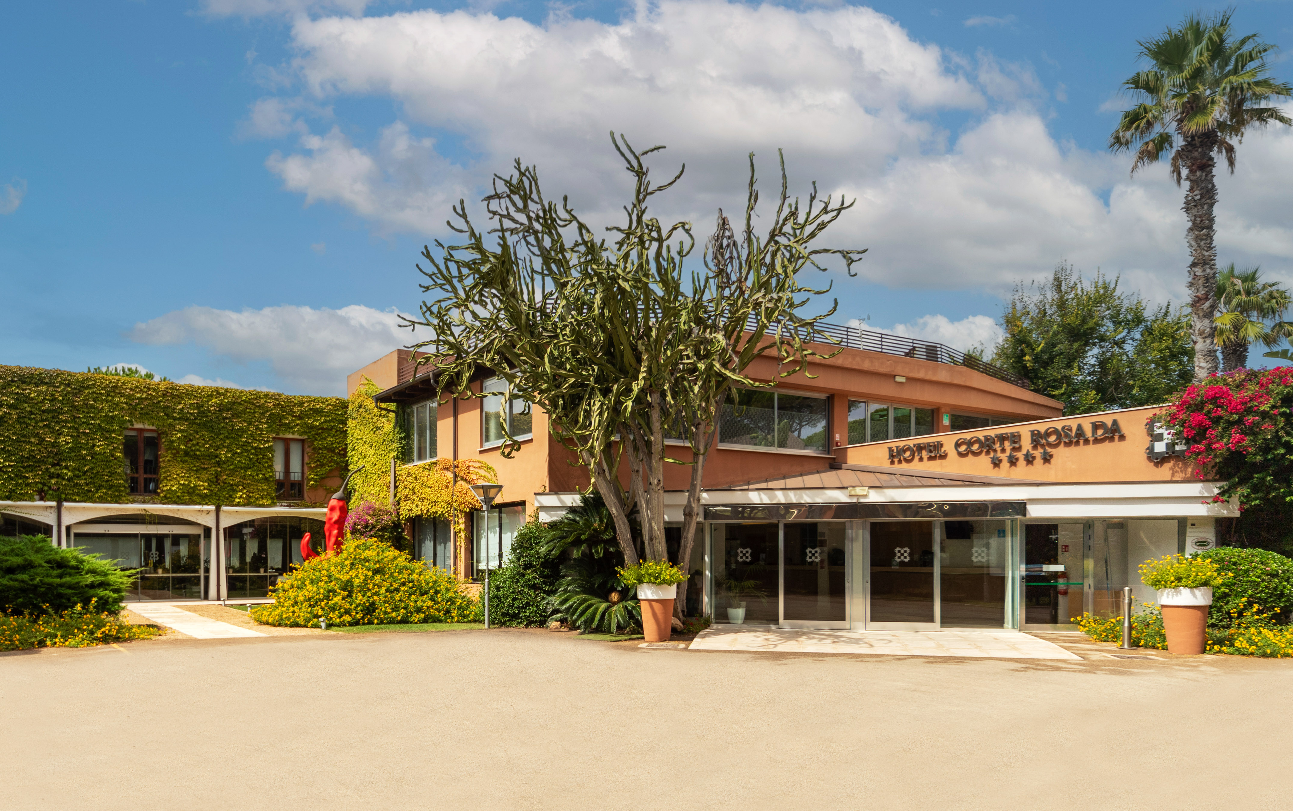 a building with a tree and a sign
