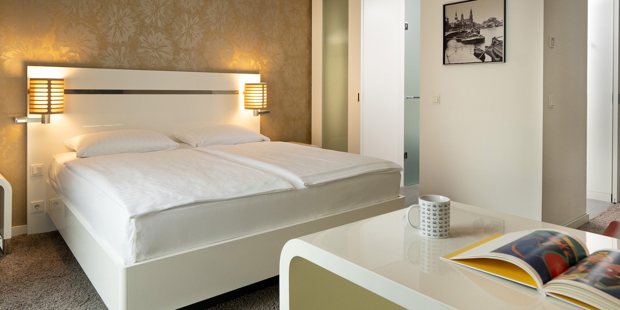 a bed with a book and a magazine on the side