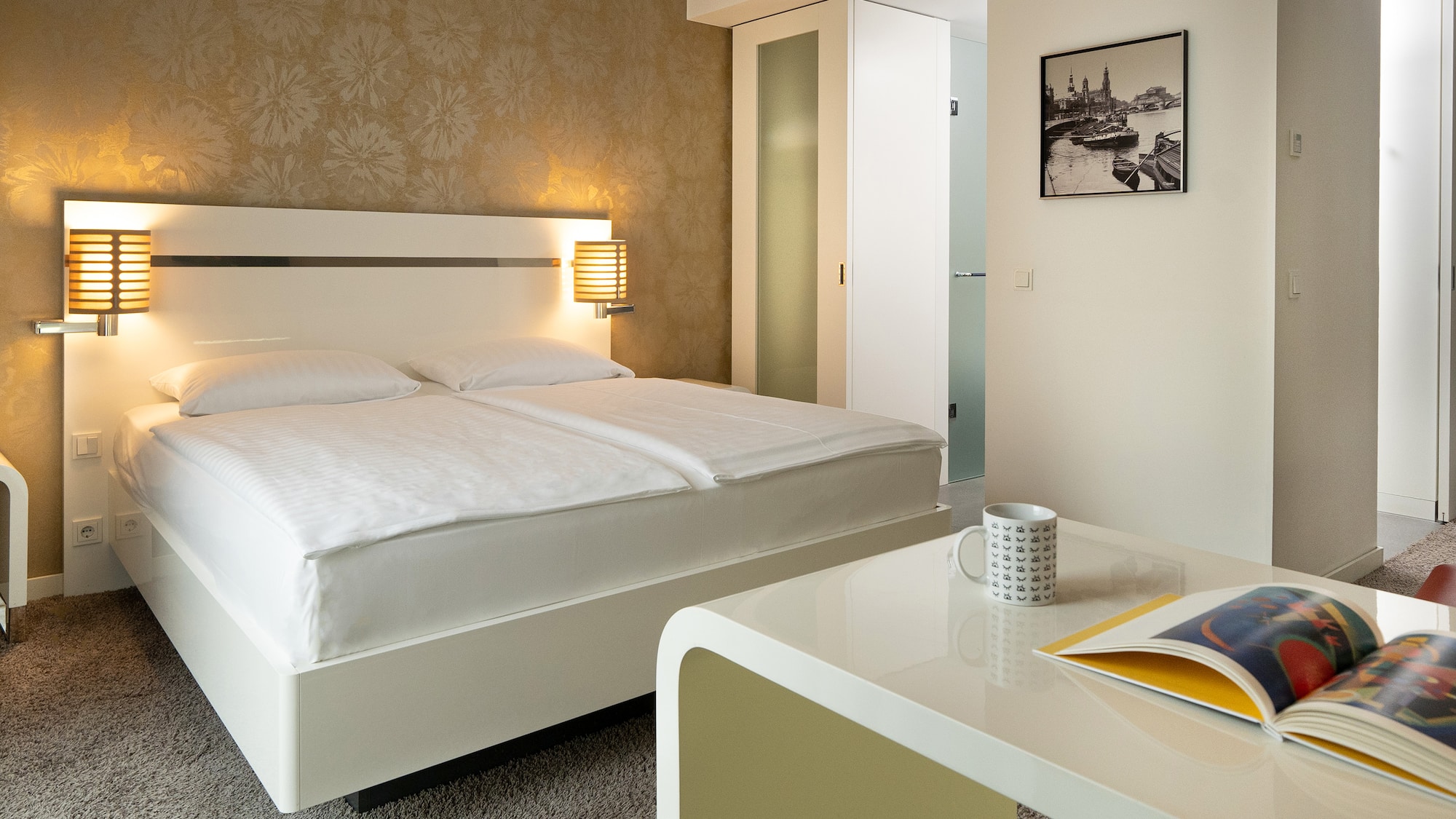 a bed with a book and a magazine on the side