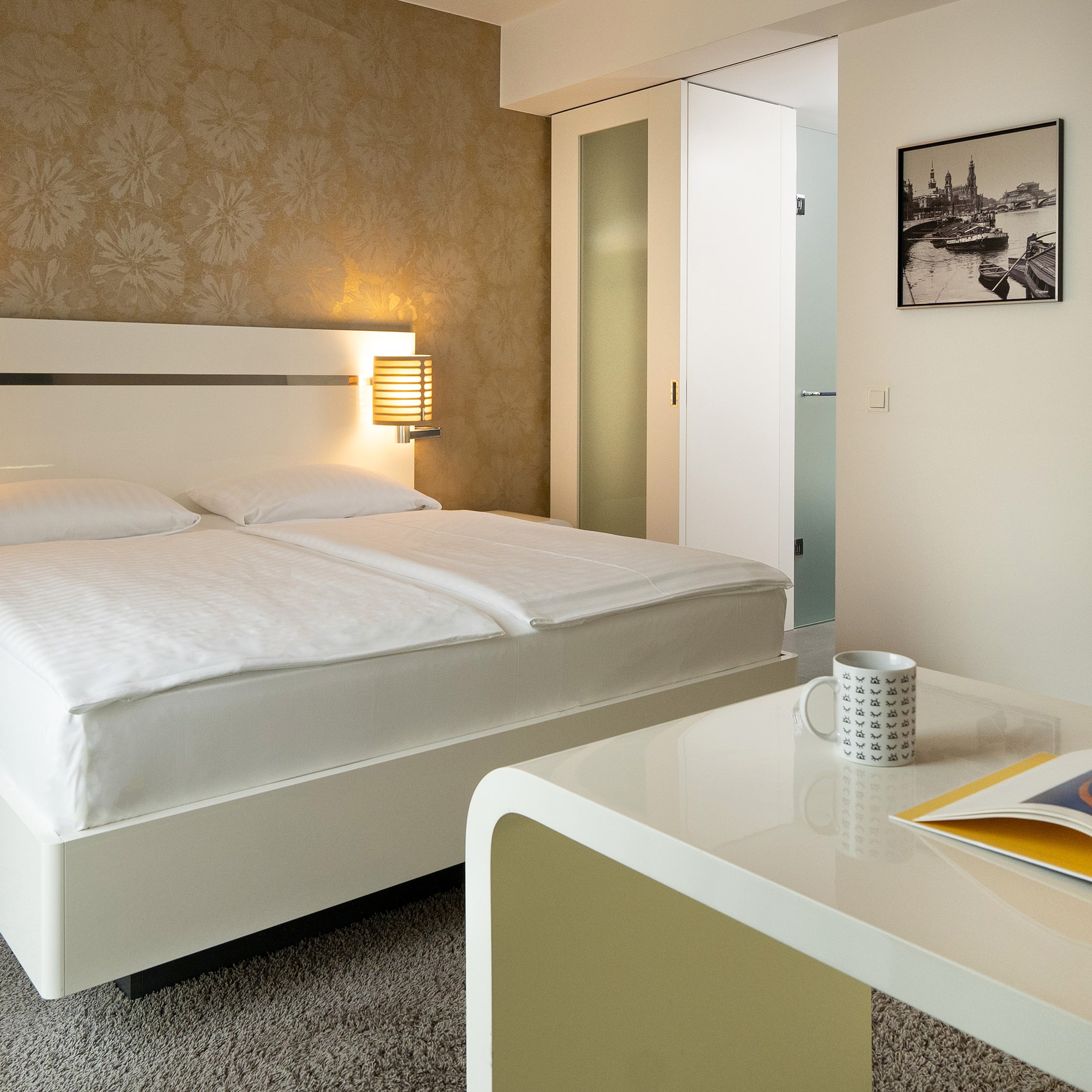 a bed with a book and a magazine on the side