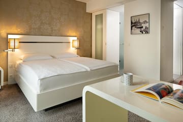 a bed with a book and a magazine on the side