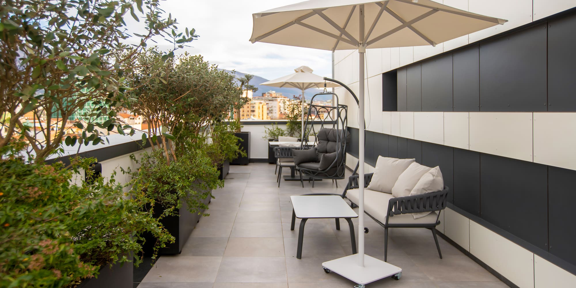 a patio with chairs and umbrellas