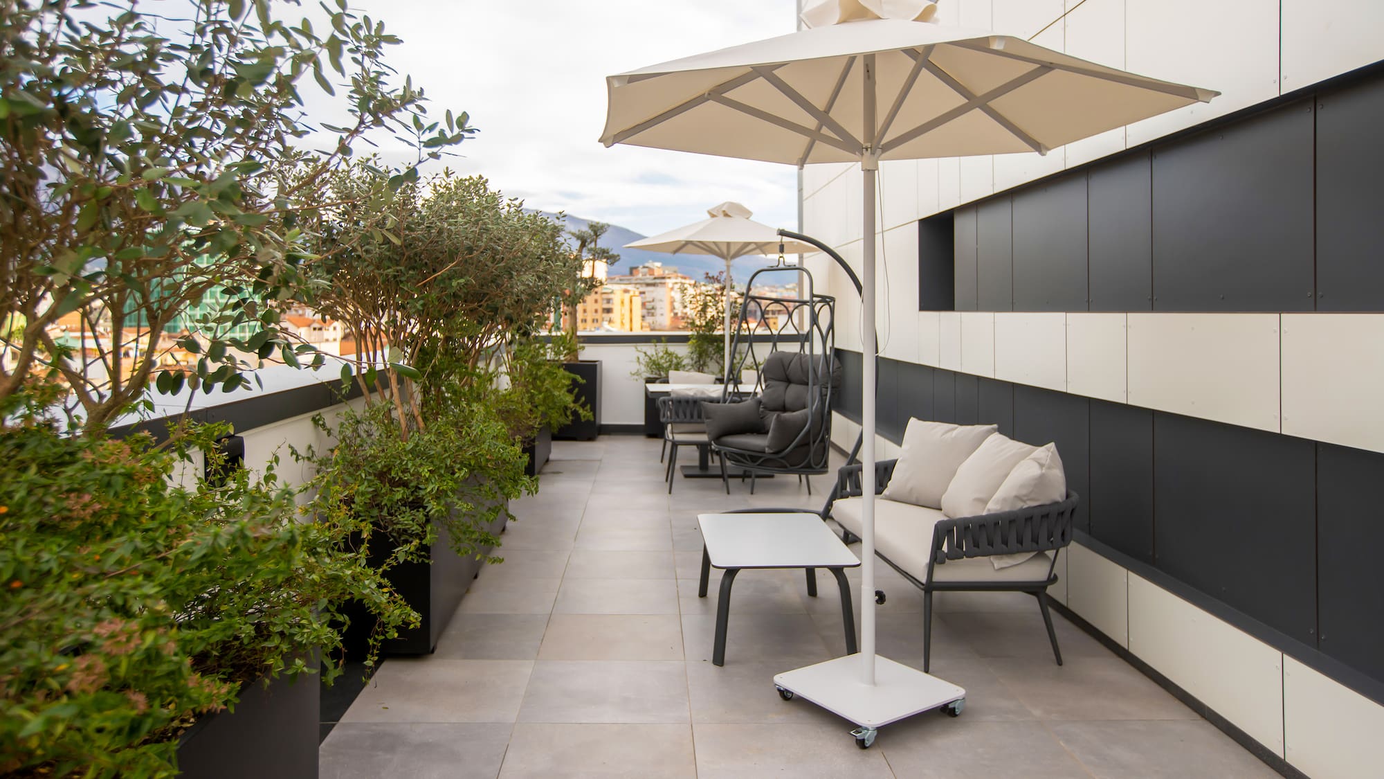 a patio with chairs and umbrellas