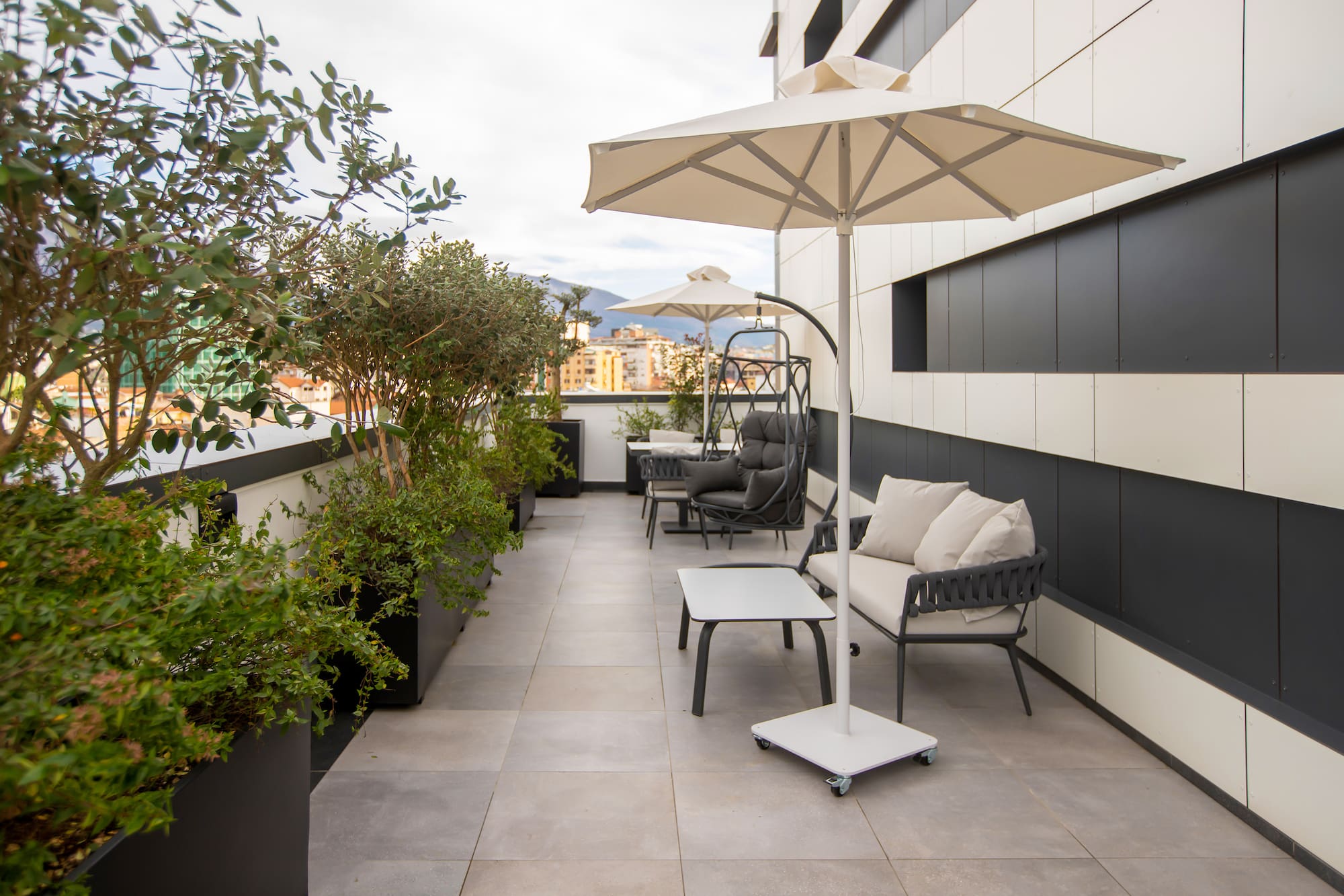 a patio with chairs and umbrellas
