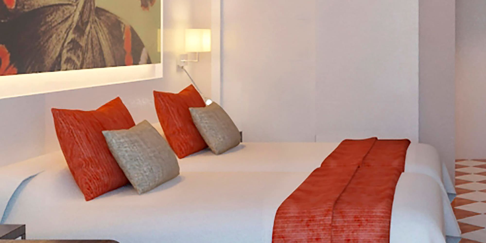 a bed with pillows and a painting on the wall