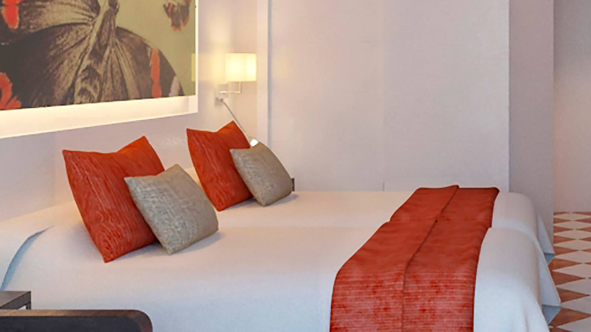 a bed with pillows and a painting on the wall