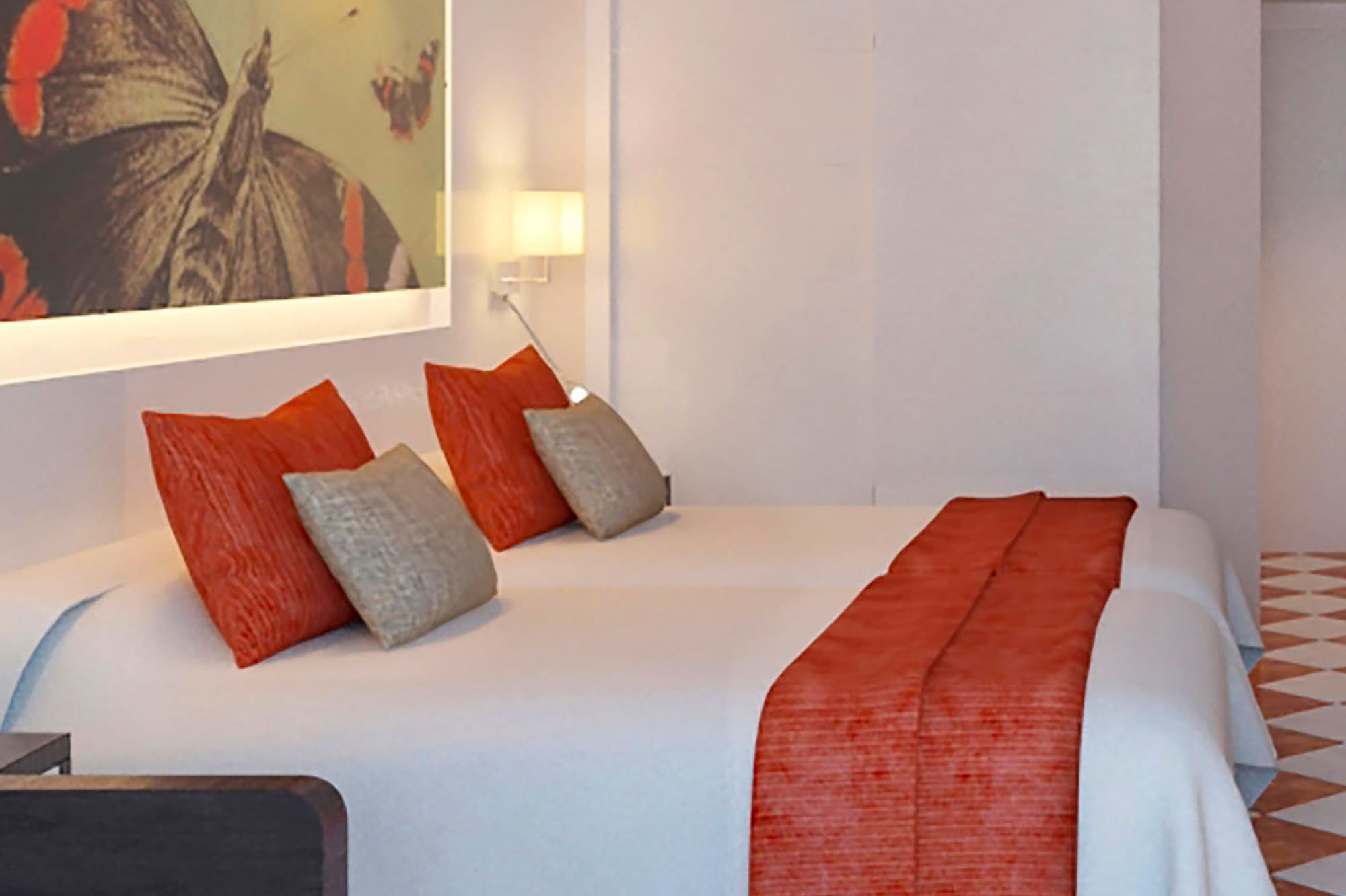 a bed with pillows and a painting on the wall