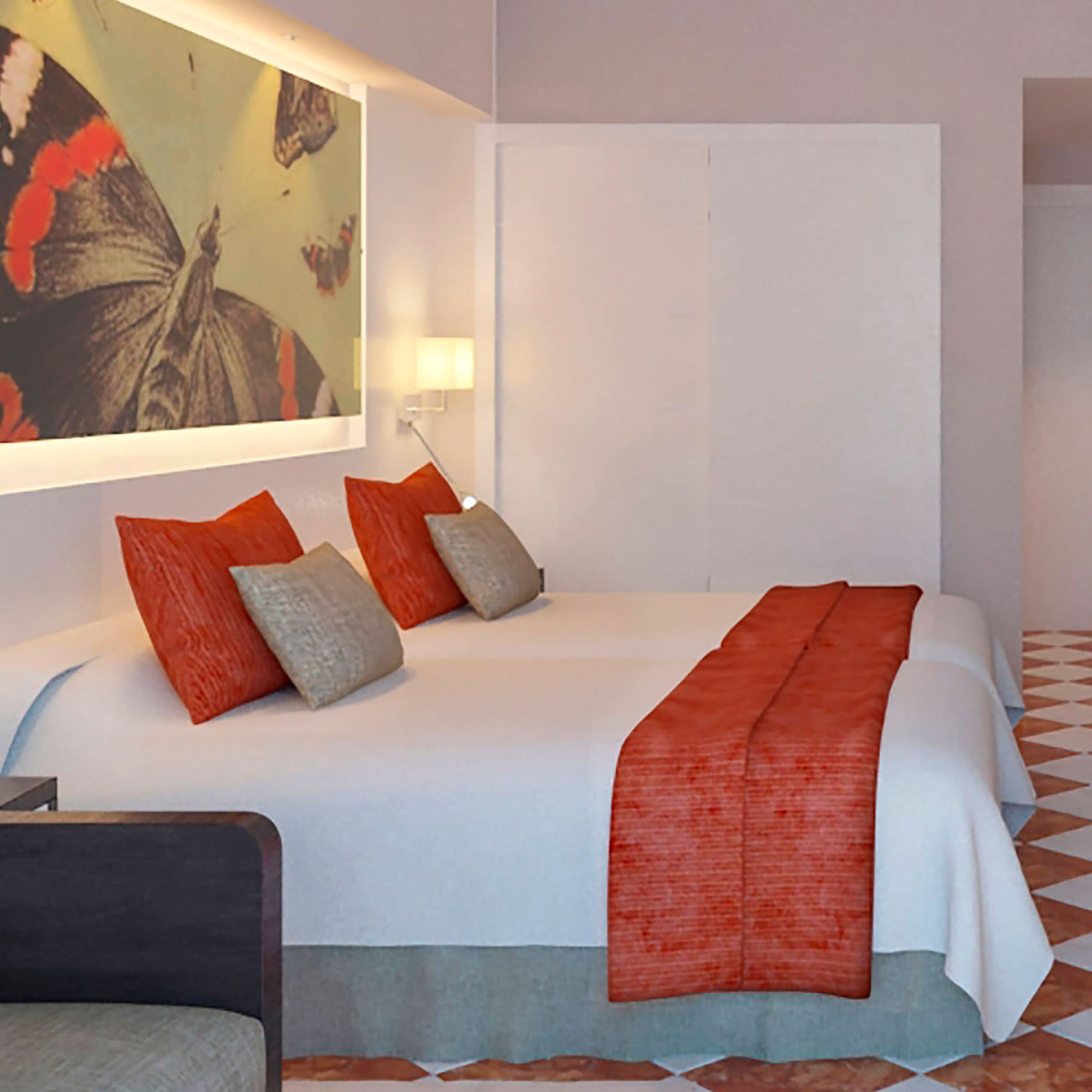 a bed with pillows and a painting on the wall