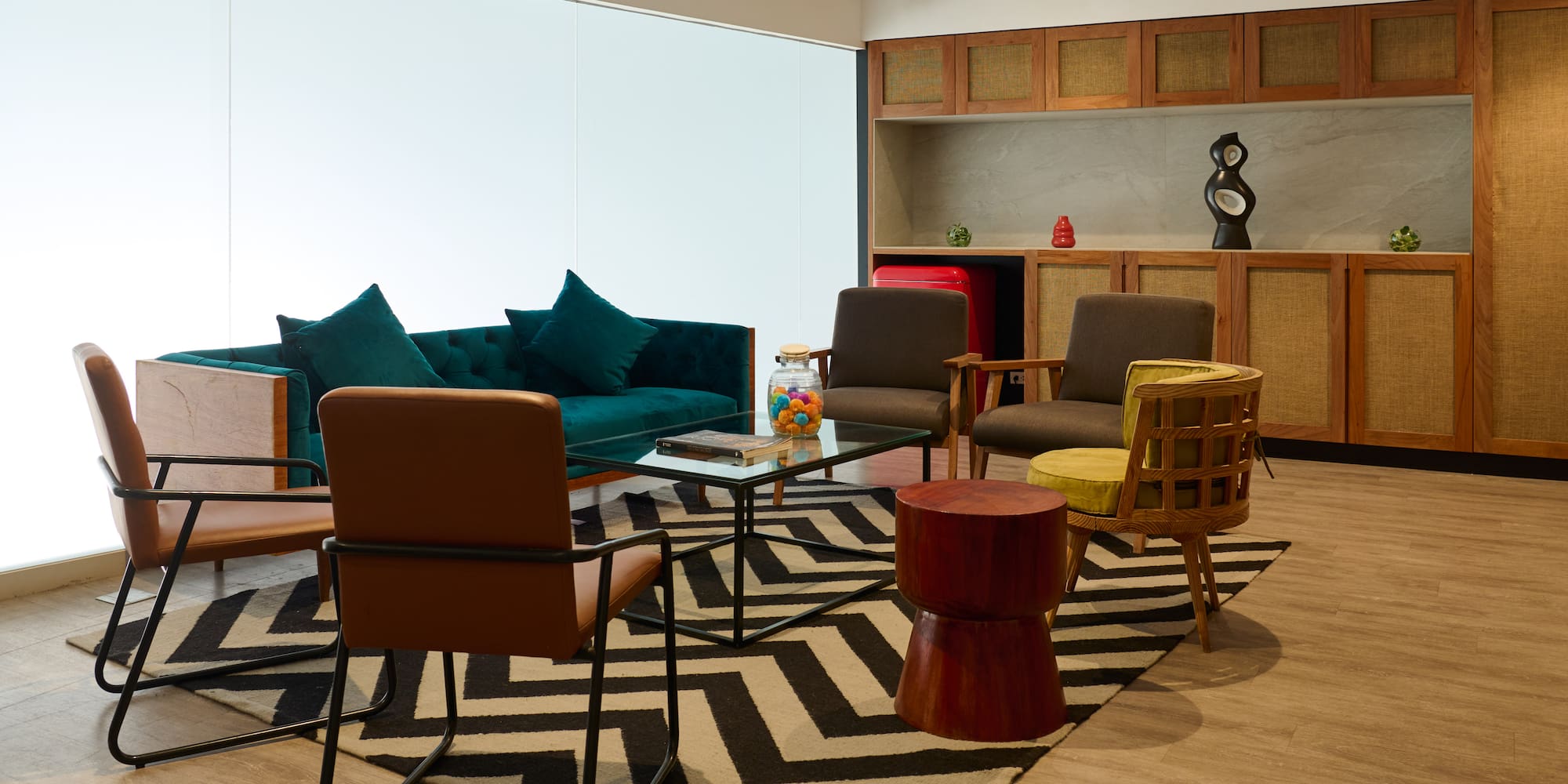 a room with a couch and chairs