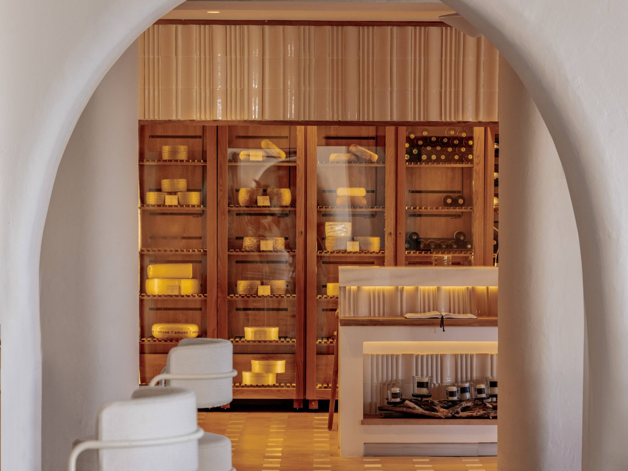 a white archway with a shelf and shelves in front of it